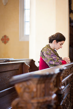 Young woman praying in a church